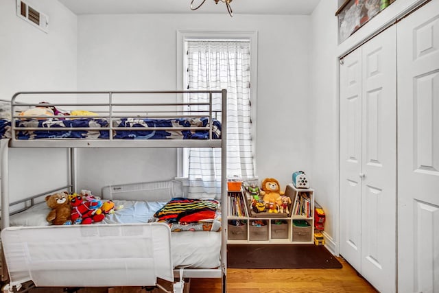 838 N Maplewood Ave Unit 1R, Chicago, IL 60622 - bedroom with wood finished floors, multiple windows, and a closet