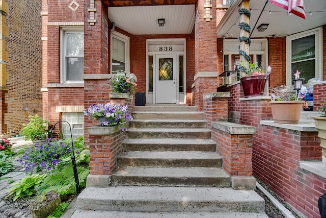 838 N Maplewood Ave Unit 1R, Chicago, IL 60622 - doorway to property with brick siding and covered porch