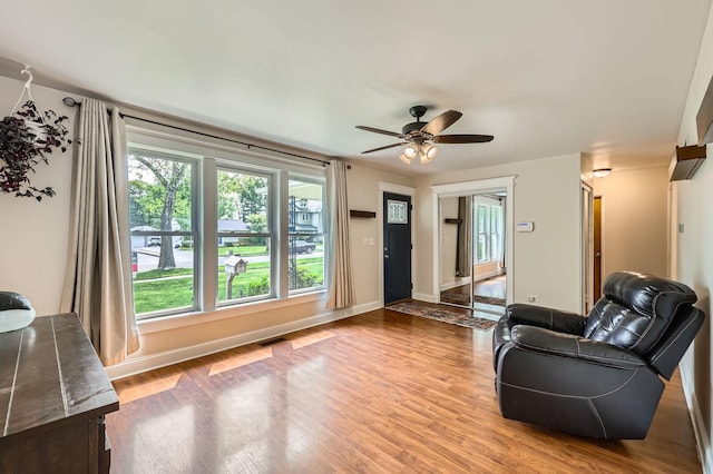 3007 Falcon Ct W, Rolling Meadows, IL 60008 - living room featuring wood finished floors, a ceiling fan, and baseboards