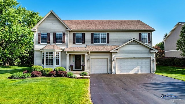 532 Nunda Trl, Crystal Lake, IL 60012 - view of front of property featuring asphalt driveway, a front yard, and a garage