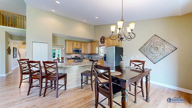 532 Nunda Trl, Crystal Lake, IL 60012 - dining room with a chandelier, light wood finished floors, baseboards, recessed lighting, and a towering ceiling
