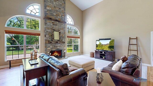 532 Nunda Trl, Crystal Lake, IL 60012 - living area featuring high vaulted ceiling, baseboards, a stone fireplace, and wood finished floors