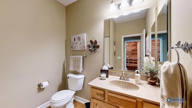 532 Nunda Trl, Crystal Lake, IL 60012 - half bathroom featuring toilet, baseboards, vanity, and wood finished floors