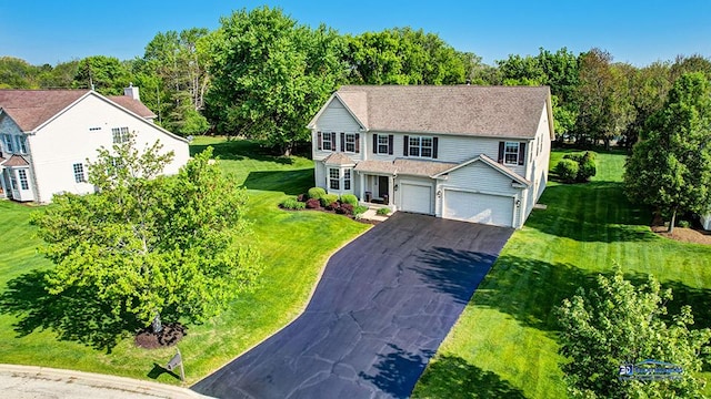 532 Nunda Trl, Crystal Lake, IL 60012 - traditional-style home with asphalt driveway, a front lawn, a garage, and view of scattered trees