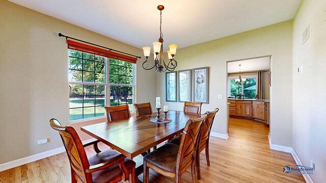 532 Nunda Trl, Crystal Lake, IL 60012 - dining room with a chandelier, light wood finished floors, and baseboards