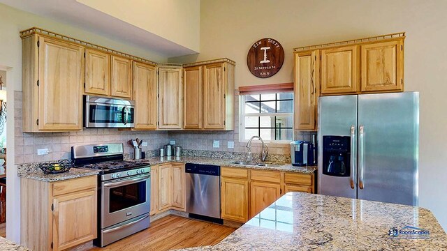 532 Nunda Trl, Crystal Lake, IL 60012 - kitchen featuring appliances with stainless steel finishes, a sink, light brown cabinets, light stone counters, and light wood-style floors