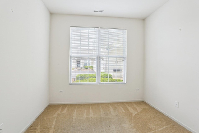 carpeted empty room featuring baseboards