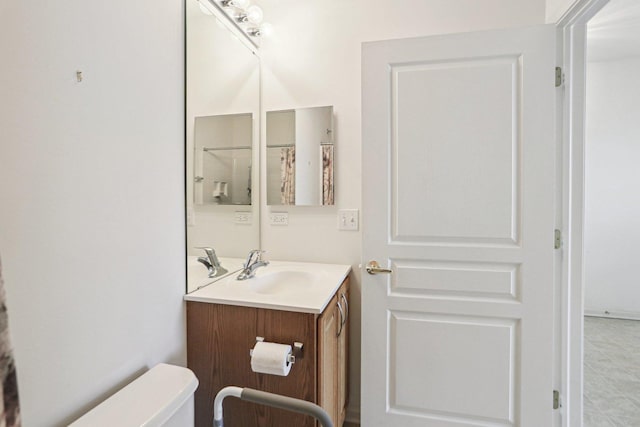 bathroom featuring toilet and vanity