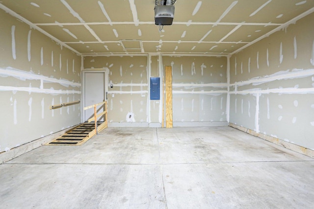 garage with a garage door opener and electric panel