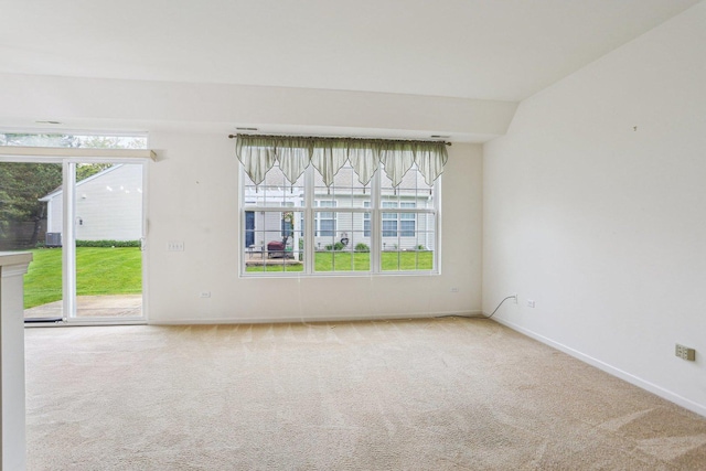 carpeted empty room featuring healthy amount of natural light and baseboards