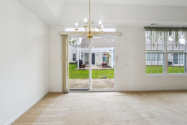 unfurnished dining area with a chandelier, carpet flooring, and baseboards