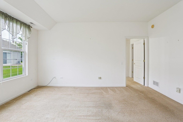 unfurnished room with light colored carpet and baseboards