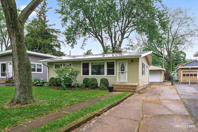 521 Division St, Saint Charles, IL 60174 - view of front of property with a garage, a front lawn, a chimney, and an outdoor structure