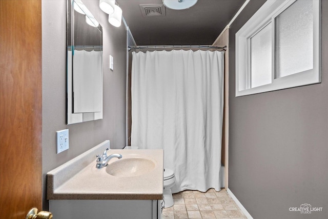 521 Division St, Saint Charles, IL 60174 - bathroom with vanity, toilet, a shower with curtain, and baseboards