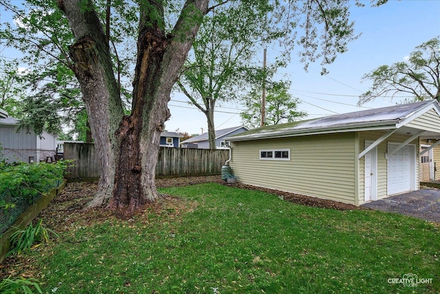 521 Division St, Saint Charles, IL 60174 - view of yard featuring an outdoor structure, asphalt driveway, and a garage