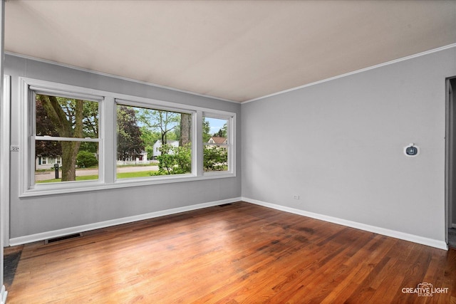 521 Division St, Saint Charles, IL 60174 - empty room featuring crown molding, baseboards, and wood finished floors