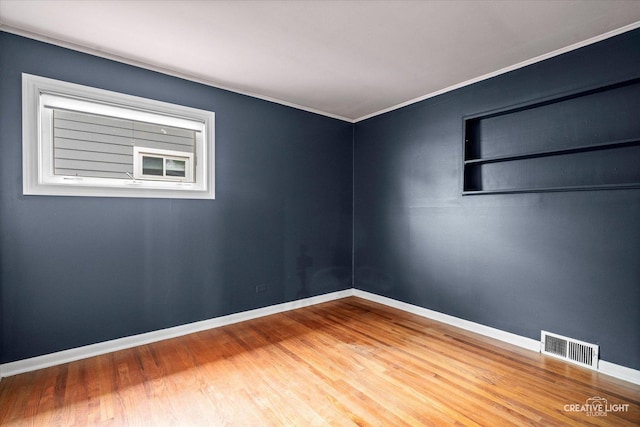 521 Division St, Saint Charles, IL 60174 - unfurnished room with ornamental molding, wood finished floors, baseboards, and built in features