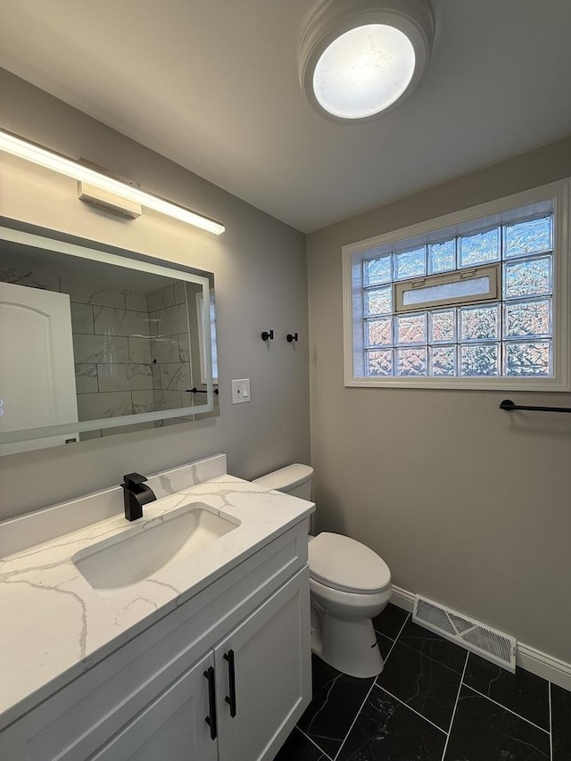 2620 W 36th Pl, Chicago, IL 60632 - bathroom featuring toilet, vanity, marble finish floors, a shower, and baseboards