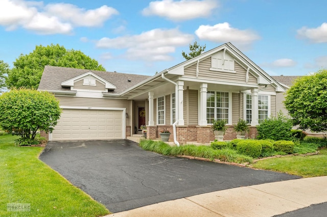 507 Parkland Ct, Oswego, IL 60543 - view of front facade with brick siding, driveway, a garage, and a front yard