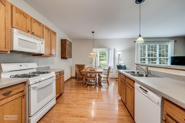 507 Parkland Ct, Oswego, IL 60543 - kitchen featuring white appliances, a sink, pendant lighting, and light wood finished floors