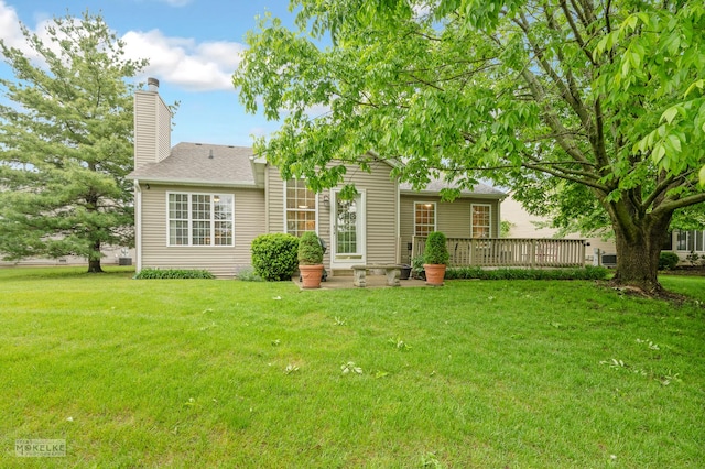 507 Parkland Ct, Oswego, IL 60543 - rear view of property with a chimney, a lawn, roof with shingles, and a wooden deck