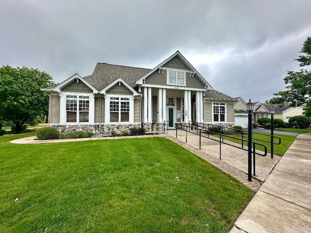 507 Parkland Ct, Oswego, IL 60543 - craftsman-style house featuring a front yard, stone siding, and roof with shingles