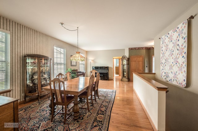 507 Parkland Ct, Oswego, IL 60543 - dining area with wallpapered walls, baseboards, and light wood-style flooring