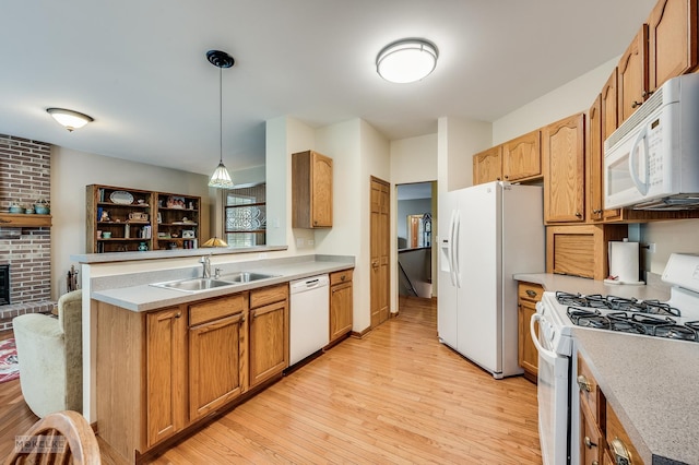 507 Parkland Ct, Oswego, IL 60543 - kitchen featuring white appliances, a sink, light wood-style floors, and light countertops