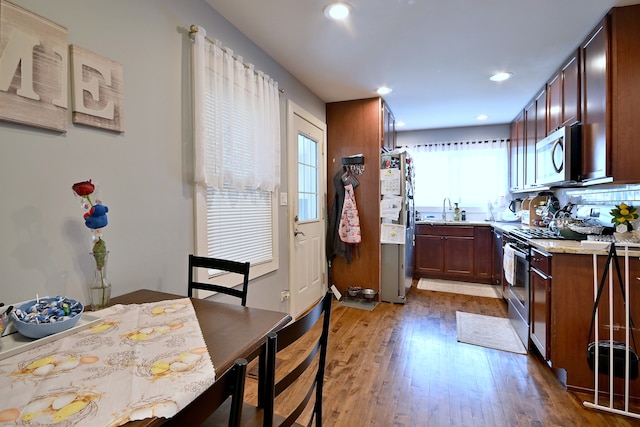 4200 Judd St, Schiller Park, IL 60176 - kitchen featuring appliances with stainless steel finishes, a sink, wood finished floors, light countertops, and recessed lighting