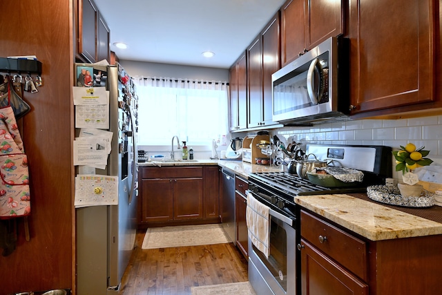 4200 Judd St, Schiller Park, IL 60176 - kitchen featuring stainless steel appliances, a sink, light wood finished floors, backsplash, and recessed lighting