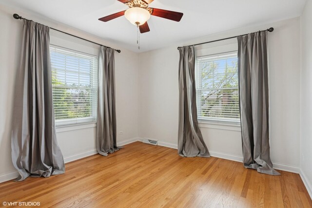 1702 Madsen Ct, Wheaton, IL 60187 - unfurnished room featuring plenty of natural light, light wood-style floors, and baseboards
