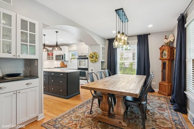1702 Madsen Ct, Wheaton, IL 60187 - dining area featuring arched walkways, light wood-type flooring, a chandelier, and recessed lighting