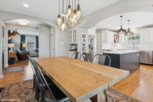 1702 Madsen Ct, Wheaton, IL 60187 - dining space with arched walkways, light wood-type flooring, a chandelier, and recessed lighting