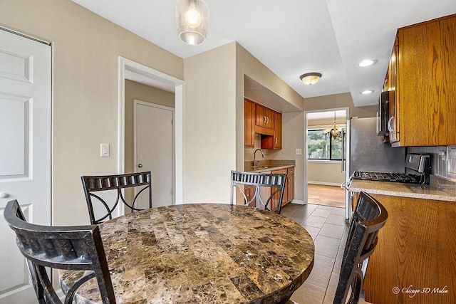 1610 Chippewa Trl, Wheeling, IL 60090 - tiled dining space featuring recessed lighting, baseboards, a sink, and a chandelier