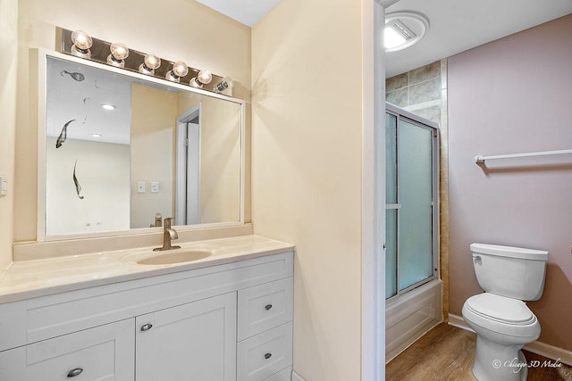 1610 Chippewa Trl, Wheeling, IL 60090 - bathroom featuring toilet, vanity, bath / shower combo with glass door, and wood finished floors