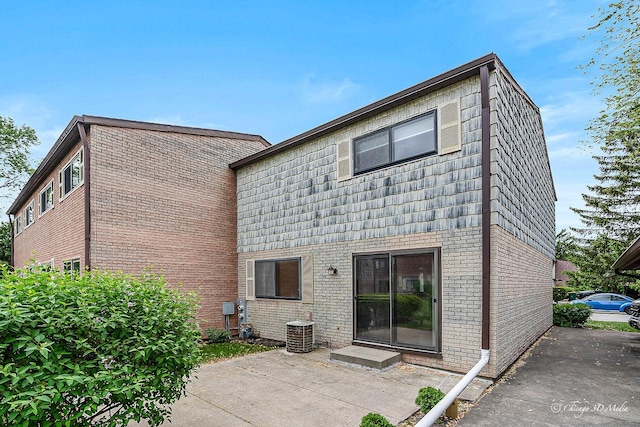 1610 Chippewa Trl, Wheeling, IL 60090 - back of house with central AC unit, brick siding, and a patio area