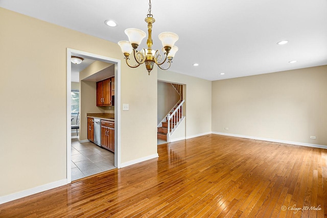 1610 Chippewa Trl, Wheeling, IL 60090 - empty room featuring stairs, light wood-style floors, a chandelier, recessed lighting, and baseboards