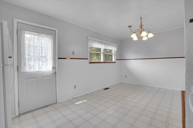 337 E Rose St, Glenwood, IL 60425 - unfurnished dining area with light floors, a chandelier, and baseboards