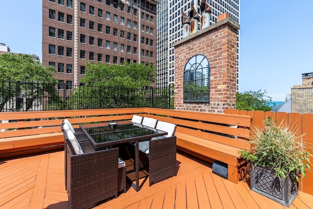 69 E Cedar St, Chicago, IL 60611 - wooden deck featuring outdoor dining space