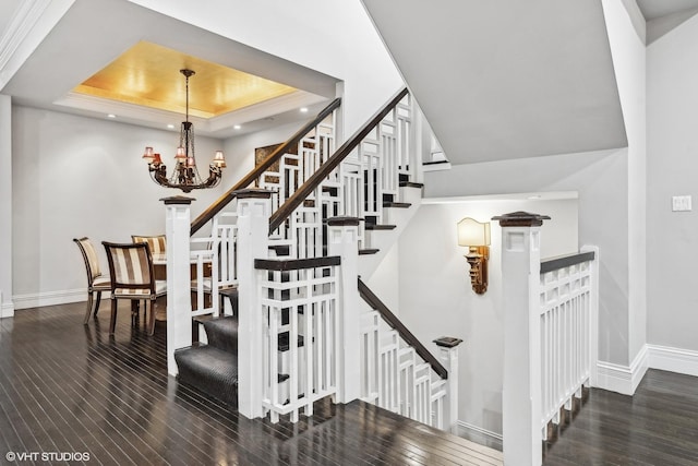 69 E Cedar St, Chicago, IL 60611 - stairway with wood-type flooring, a chandelier, a tray ceiling, baseboards, and recessed lighting