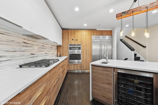 69 E Cedar St, Chicago, IL 60611 - kitchen with beverage cooler, stainless steel appliances, modern cabinets, light countertops, and decorative backsplash
