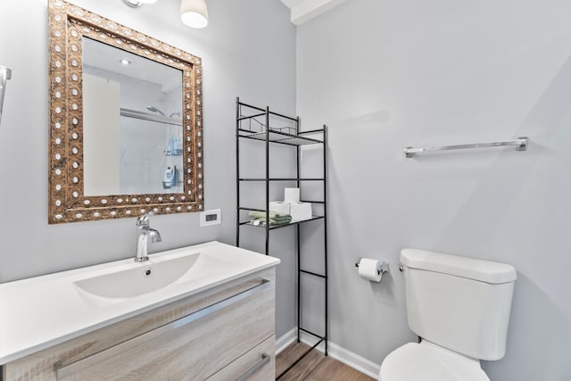 410 Meadow Green Ln, Round Lake, IL 60073 - bathroom featuring toilet, a shower, vanity, wood finished floors, and baseboards