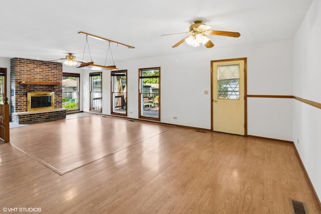 236 S Edgewood Ave, Lombard, IL 60148 - unfurnished living room featuring a ceiling fan, wood finished floors, and a brick fireplace
