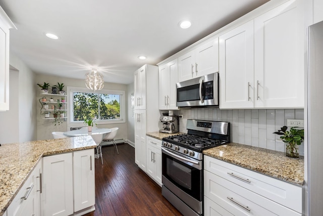 1205 E Hintz Rd Unit 212, Arlington Heights, IL 60004 - kitchen with appliances with stainless steel finishes, tasteful backsplash, white cabinetry, dark wood-style flooring, and a chandelier