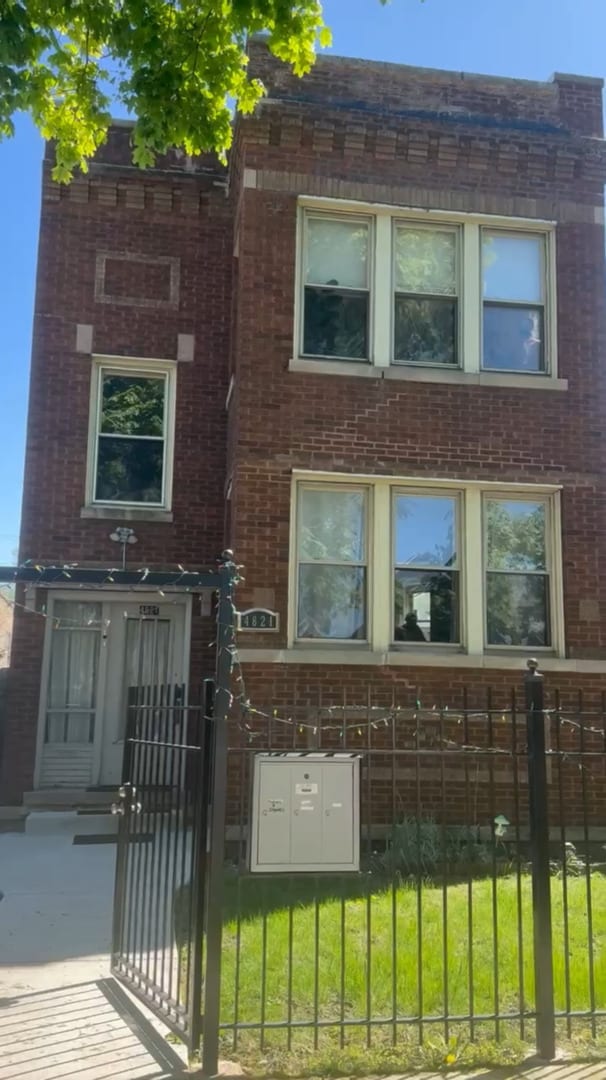 4821 W Wrightwood Ave, Chicago, IL 60639 - front of property featuring brick siding and a gate