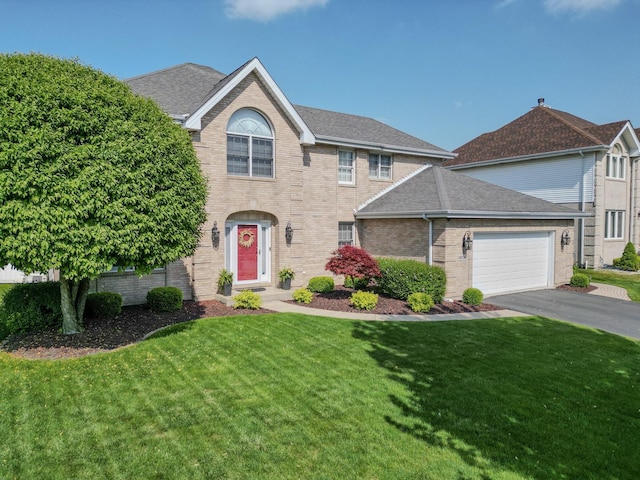 18132 Crystal Ln, Lansing, IL 60438 - view of front facade with a front lawn, brick siding, asphalt driveway, and roof with shingles