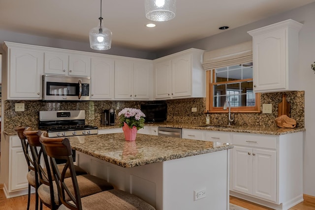 18132 Crystal Ln, Lansing, IL 60438 - kitchen with stainless steel appliances, a sink, light wood-style flooring, and light stone countertops