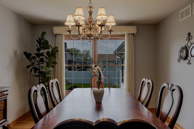18132 Crystal Ln, Lansing, IL 60438 - dining space featuring a chandelier, baseboards, and wood finished floors
