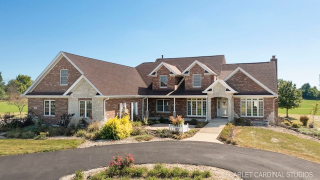 1502 Cherry Rd, Oswego, IL 60543 - view of front of home with a chimney, brick siding, a front lawn, and roof with shingles