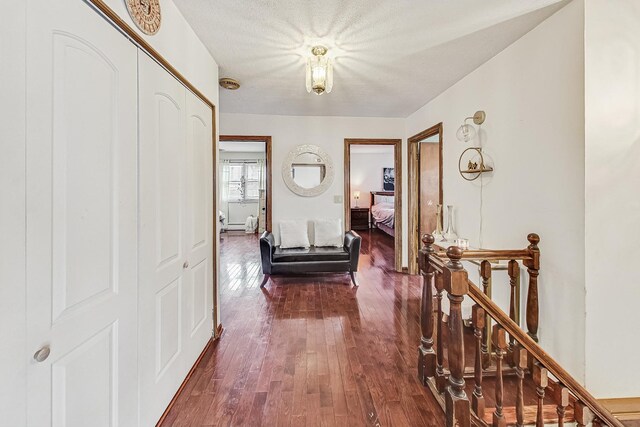 8404 N Greenwood Ave, Niles, IL 60714 - corridor with dark wood-style floors and an upstairs landing